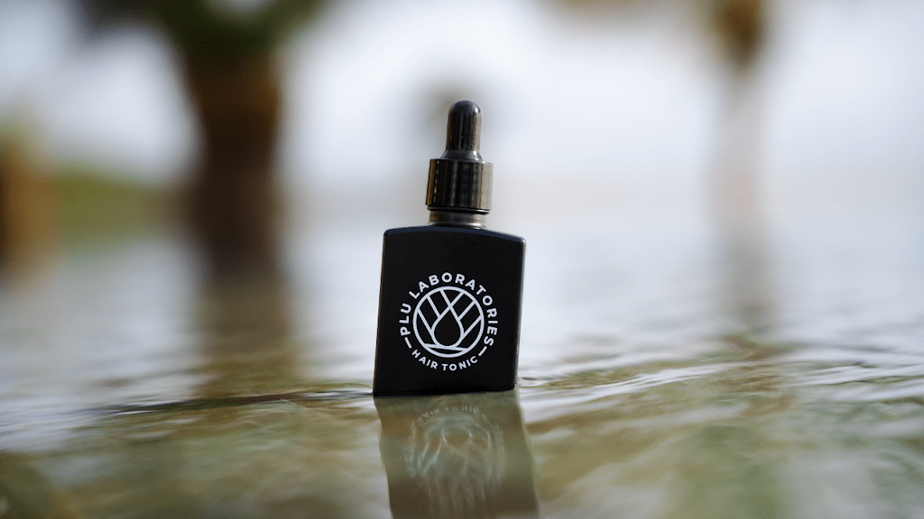 GHK-Cu Hair Tonic on a pool ledge