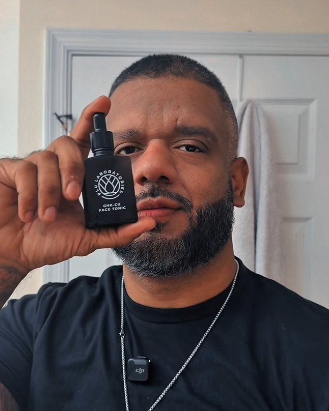A customer holding the GHK-Cu Face Tonic up to the camera